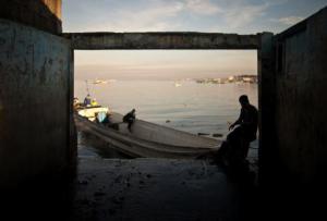 A Filipino fisherman rests at one of the fish markets near Manila. Ezra Acayan/Demotix. All rights reserved